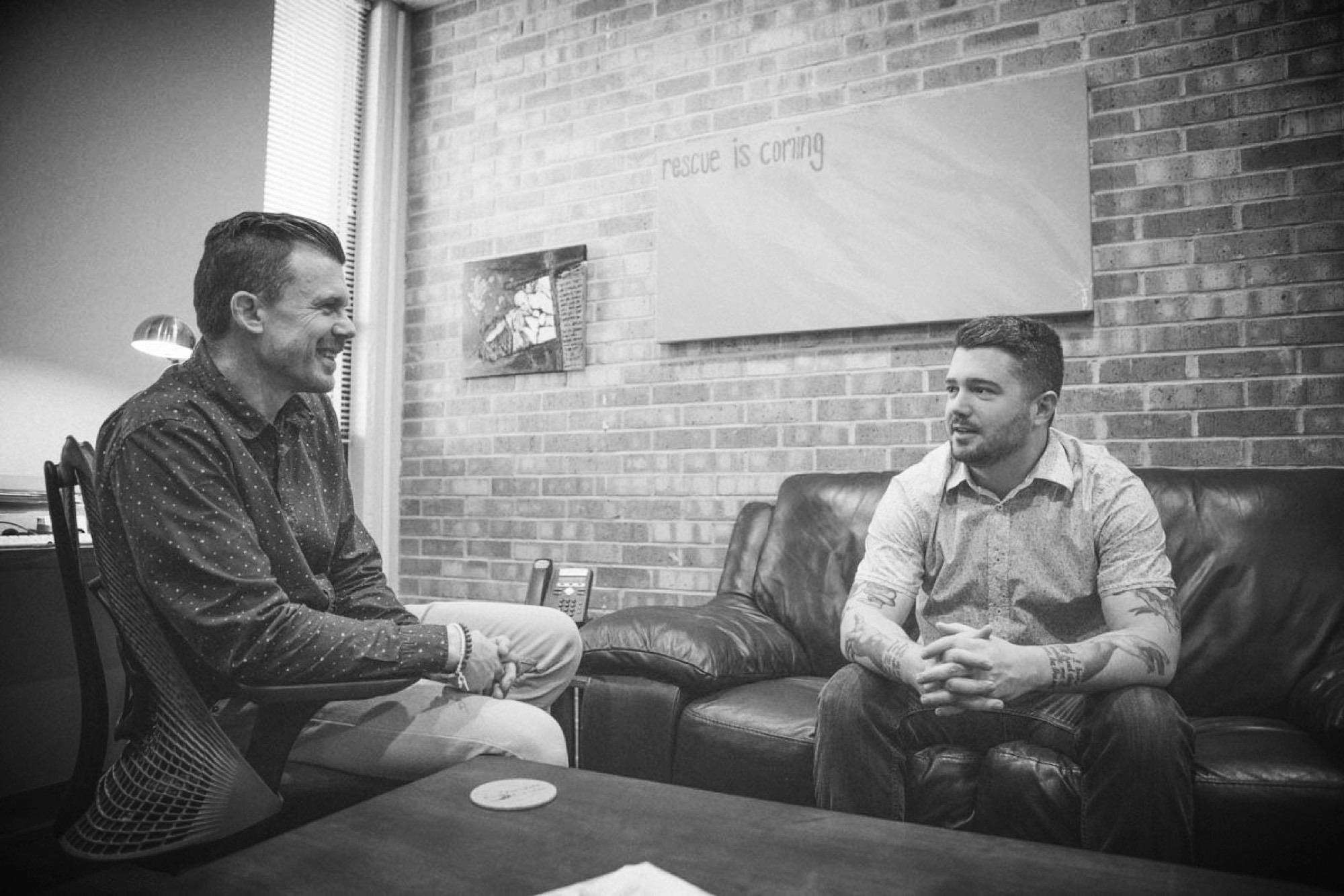 Two men sitting together in conversation
