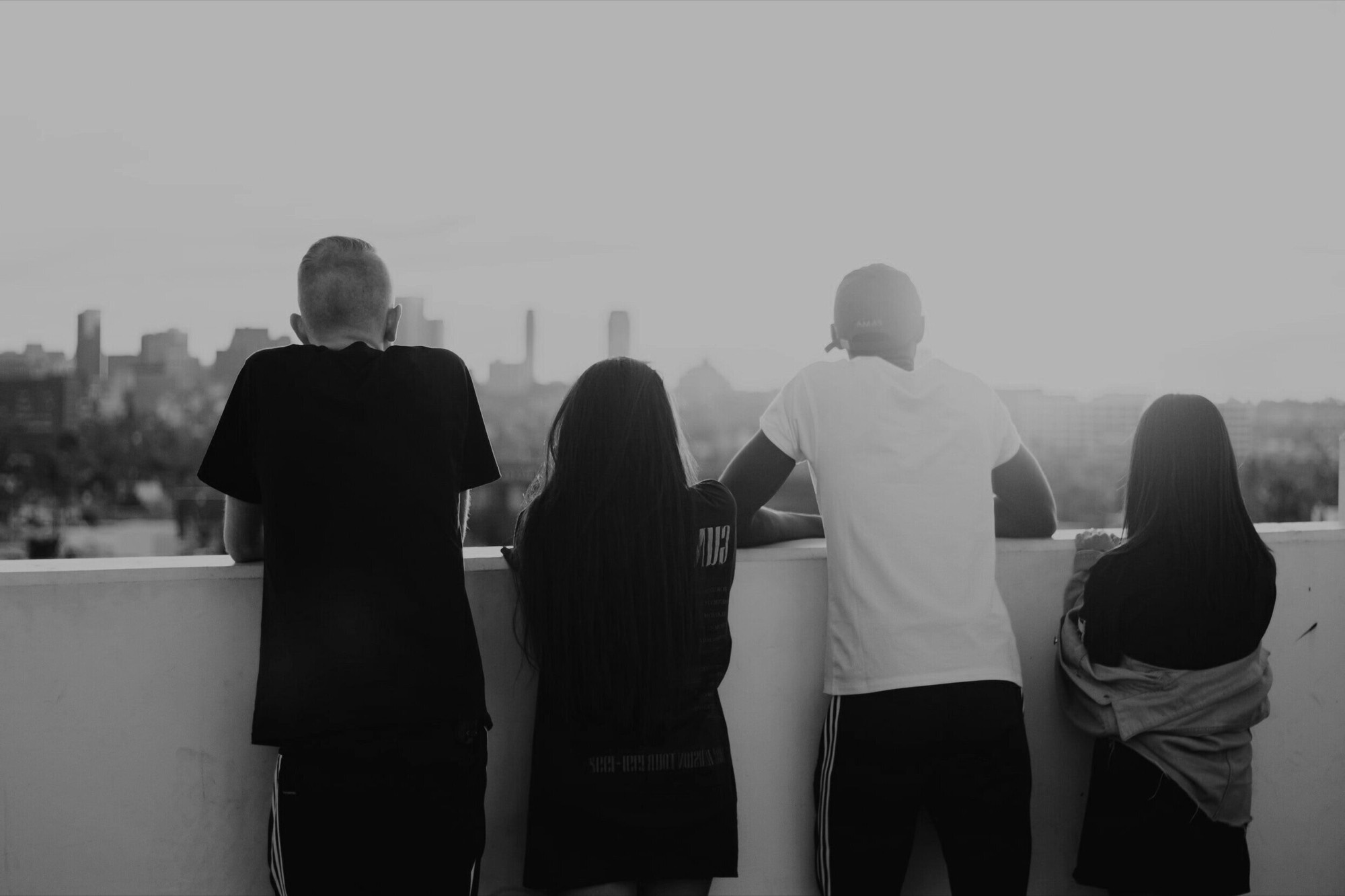 Four people together overlooking a city